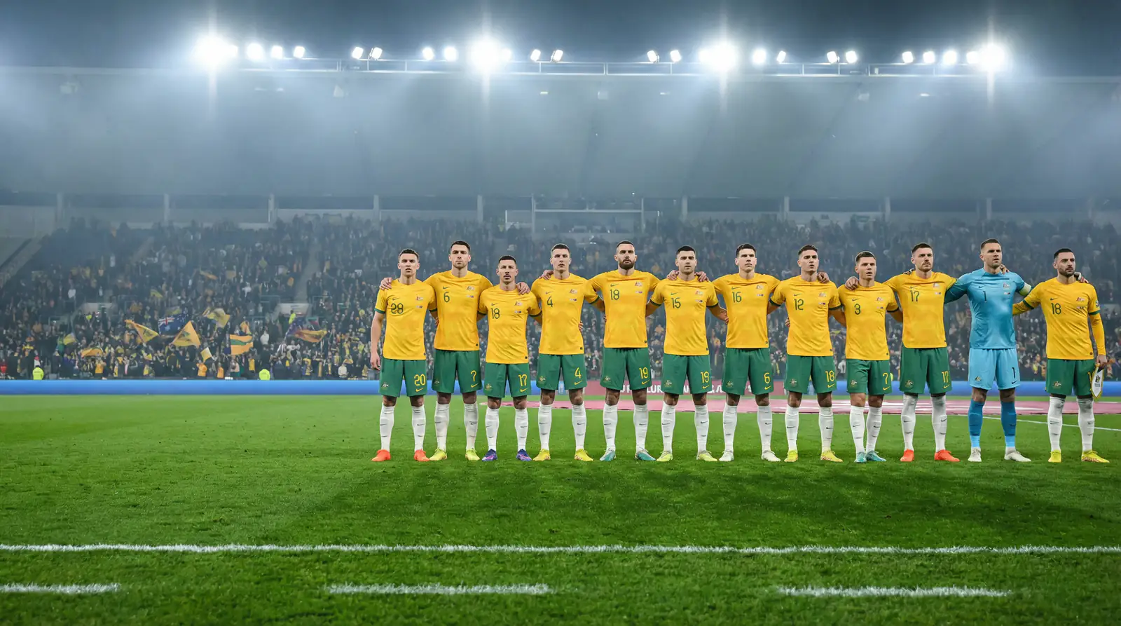 Socceroos players in green and gold lining up before a World Cup 2026 qualifier