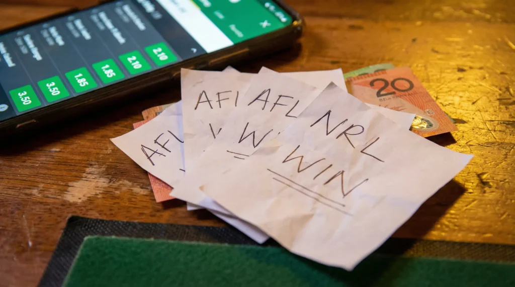 Sports betting slips with picks, cash, and mobile betting app for multi bet strategy